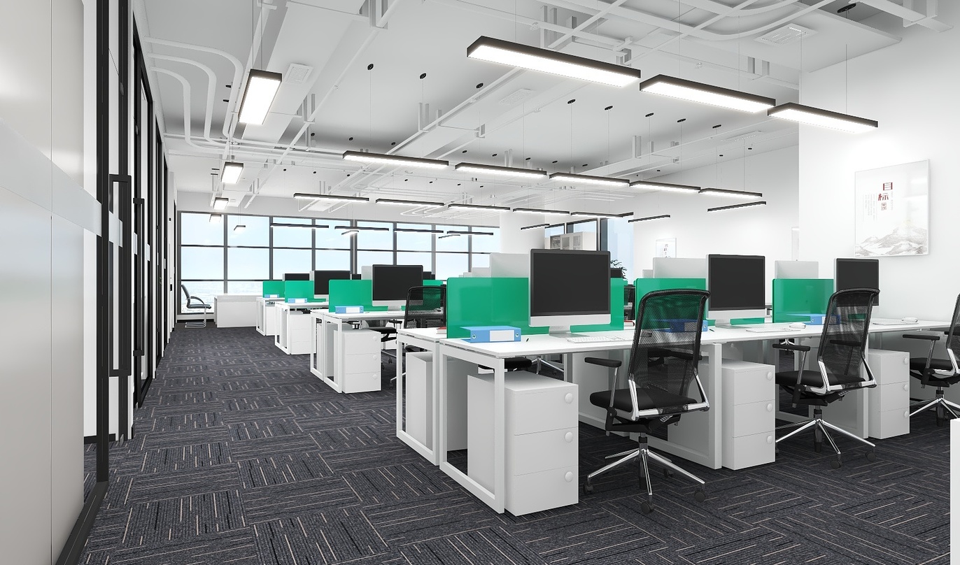 图中是一个大型的办公室，视野开阔，光线充足。灰色的地毯上整齐地排列着白色的办公桌，每张办公桌上都放着一台黑色的电脑和一把黑色的椅子。这些办公桌沿着办公室的墙壁依次排列，一直延伸到远处的拐角。在办公桌之间，还间隔着一些绿色的屏风，既保持了私密性，也增加了办公室的美观性。在办公室的尽头，有一排窗户，窗帘都拉在一边，透过窗户可以看见外面的景色。在办公室的右侧，有一面黑框的玻璃墙，墙的旁边有一张白色的纸，可能是展示板。办公室的吊顶上安装了多个灯，既提供了充足的照明，也营造了舒适的办公环境。整体来看，这个办公室设计得非常合理，既满足了员工的工作需求，也考虑了员工的工作体验。