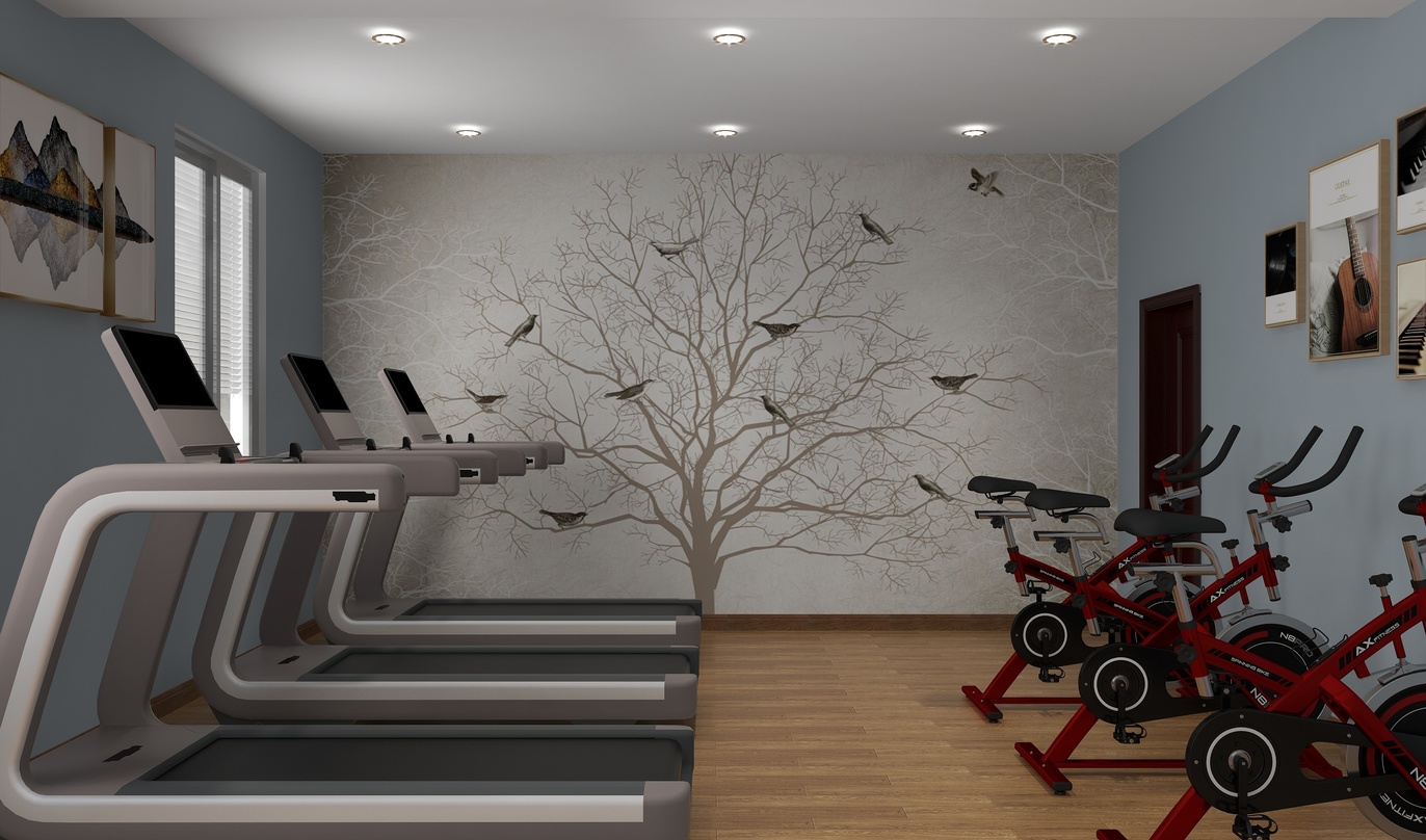 这个房间是健身房，有三台健身器材，地面是棕色的木地板，另外墙壁上还挂着一些器材。